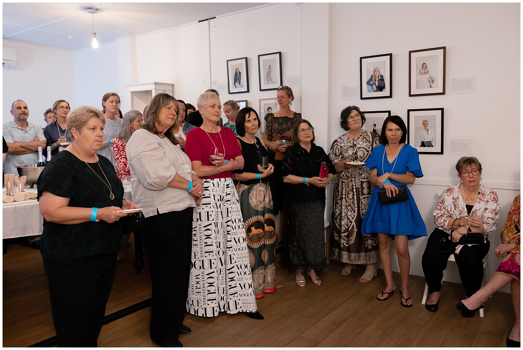 A room full of women mingling at the 40 Over 40 Project exhibition in the Barrel Room, Mackay QLD