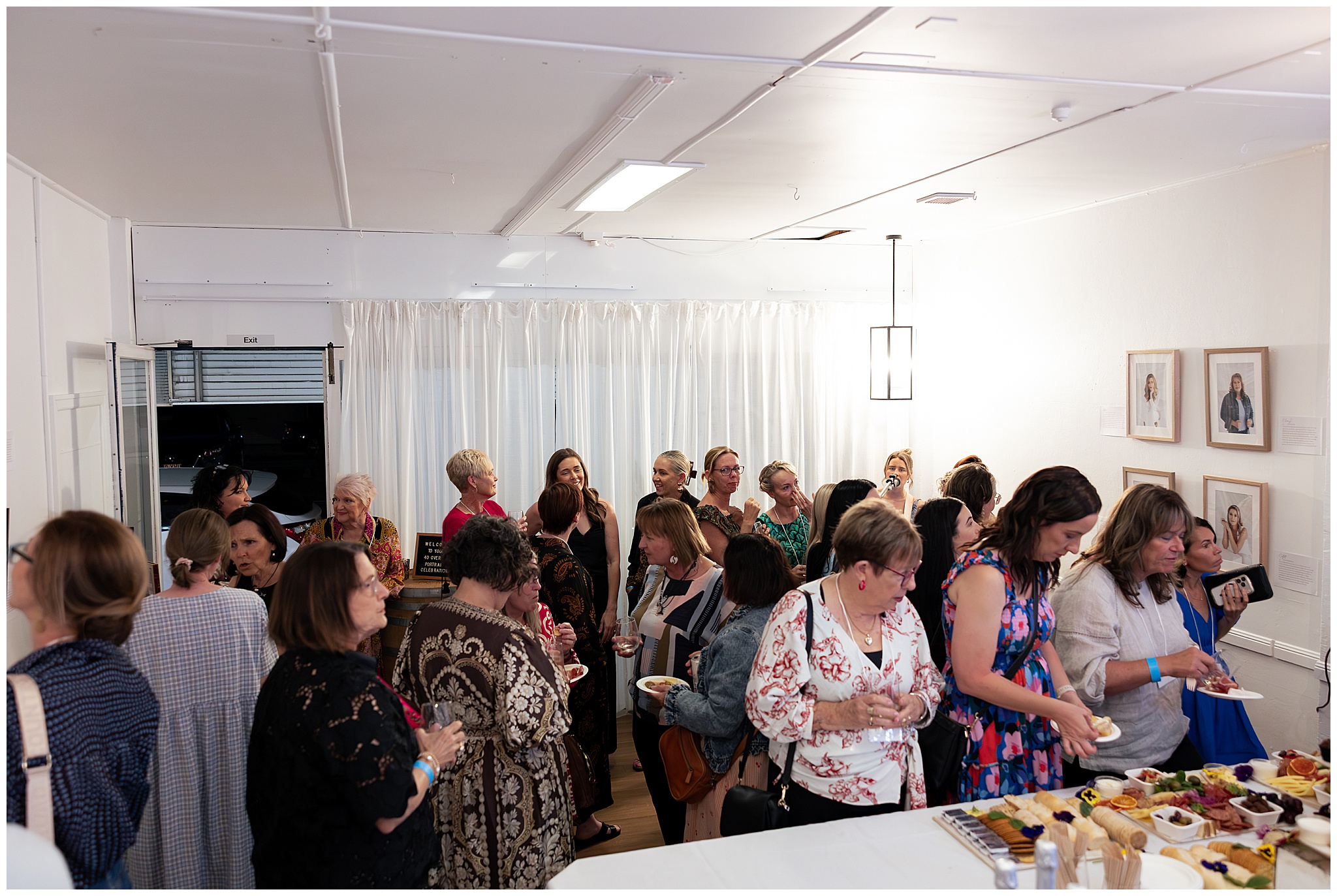 A full room of guests listening to the speeches at the 40 Over 40 celebration